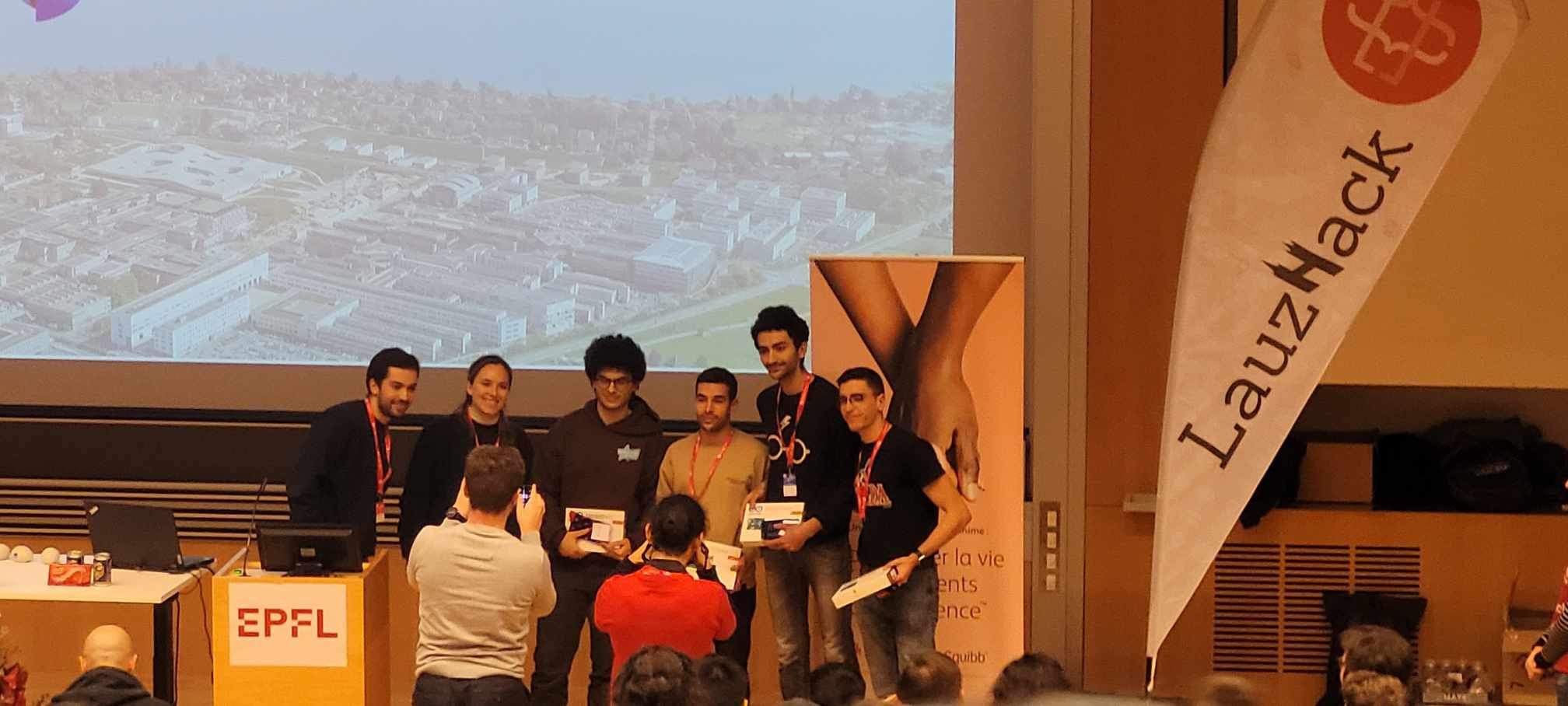 Our team receiving the Swisscom prize on the EPFL stage at LauzHack 2023